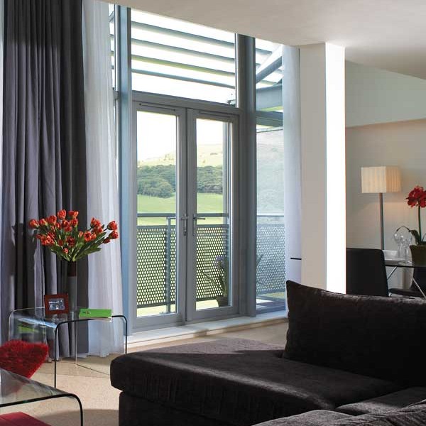 Grey french doors that open onto a balcony